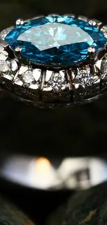 A luxurious diamond ring with a vivid blue center stone on a dark background.