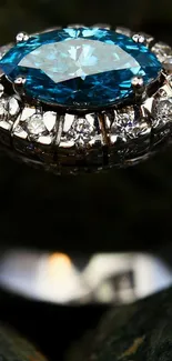 Close-up of a diamond ring with blue gemstone on a dark background.