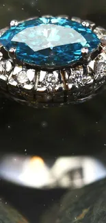 Close-up of a diamond ring with a blue gemstone on textured stones.