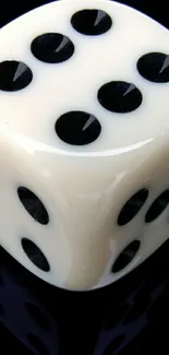 Ivory dice with black dots on a sleek dark background.