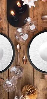 Elegant dining table with black and white plates, rustic decor, and candles.