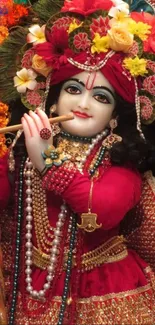 Divine figure playing flute in vibrant red attire with floral embellishments.