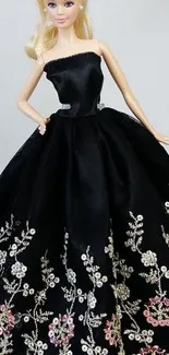 Elegant doll wearing black floral embroidered dress.