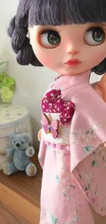 Beautiful doll in a pink kimono with floral details.