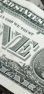 Close-up of a dollar bill with intricate details in green hues.