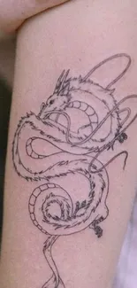 Intricate arm tattoo with dragon design on skin.