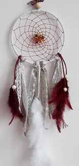 Dreamcatcher with lace and feathers on white background.