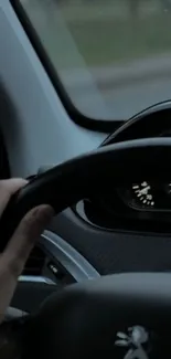 Close-up of car steering wheel and dashboard in a sleek interior setting.