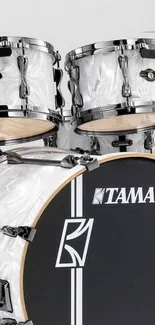 Glossy white drum set with elegant design.