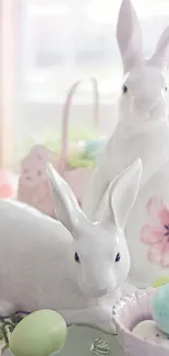 White ceramic Easter bunnies with pastel eggs and floral accents.