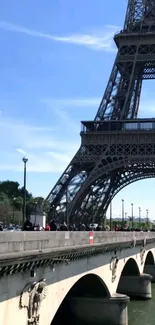 Close-up view of the Eiffel Tower against a blue sky.