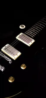 Black electric guitar with golden knobs and pickups on a dark background.