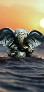 Elephant statue in serene sunset over water mobile wallpaper.