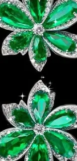 Emerald flowers with gemstones on black background.