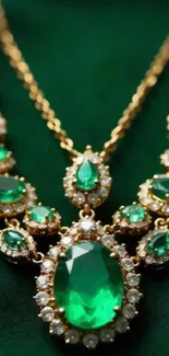 Elegant emerald necklace with gold accents on a green background.