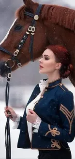 Woman in navy coat with horse on snowy day.