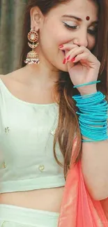 Woman in elegant ethnic attire with vibrant accessories.