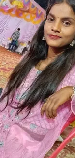 Woman in pink dress at a celebration.