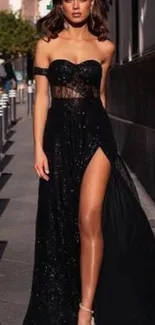 Elegant woman in a black evening dress on a city street.