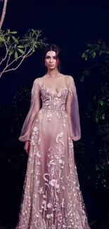 Woman in floral embroidered evening gown with a forest backdrop.