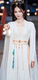 Woman in traditional attire with sparklers, evening setting.