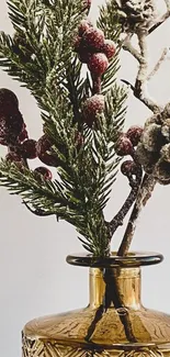 Elegant festive arrangement with pinecones in a glass vase.