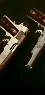 Two classic 1911 pistols on a dark background wallpaper.