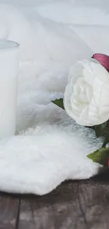 Elegant wallpaper with flowers, a candle, and a white blanket.