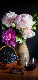 Elegant flower arrangement with grapes and wine in a vase.