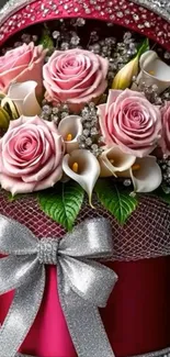 Elegant floral arrangement with pink roses and silver accents in a decorative box.