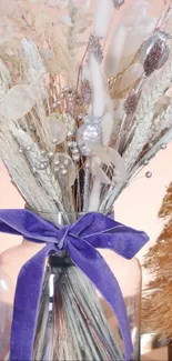 Elegant floral arrangement with lavender hues and festive decor in a clear vase.