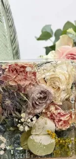 Elegant floral art in a glass vase with a pastel rose bouquet.