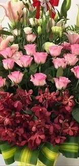 Vibrant floral bouquet with pink roses and lilies in a decorative basket.