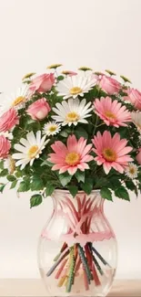 Floral bouquet in a glass vase with pink and white flowers.