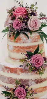 Three-tier cake with pink roses and greenery, perfect for weddings.