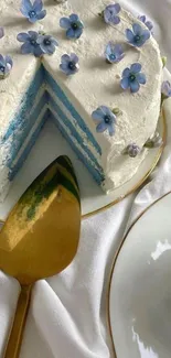 Elegant cake with blue flowers on white background.