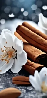 White flowers and cinnamon sticks on textured surface.