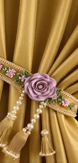 Gold curtain with floral embellishment and tassels.