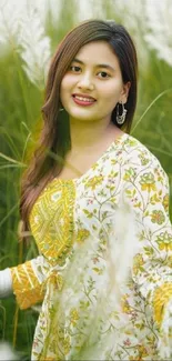 Woman in a floral dress amidst tall green grass in a peaceful scenery.