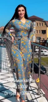 Woman in floral dress on rooftop walkway with city view.