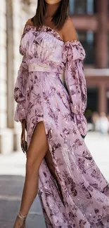 Woman in an elegant floral dress on a sunny day.