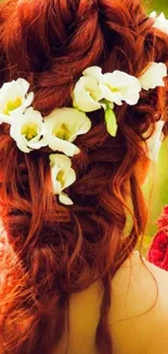 Red hair braided with white flowers for a romantic look.