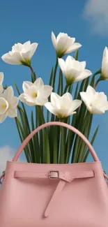 Pink handbag with white flowers against blue sky.