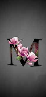 Elegant black wallpaper with letter M and pink flowers.