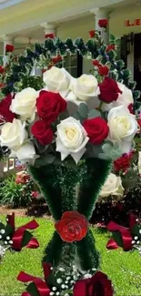 Bouquet of red and white roses in a garden setting.