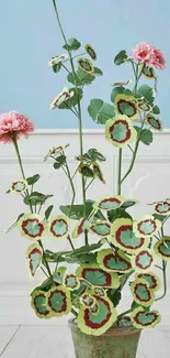 Elegant floral wallpaper with pink flowers in a pot against a sky blue wall.