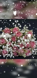 Pink roses and baby's breath with falling snowflakes on a dark background.