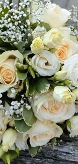 A bouquet of cream and white roses on a textured surface.