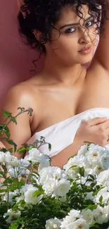 Elegant woman with white roses against a pink background.