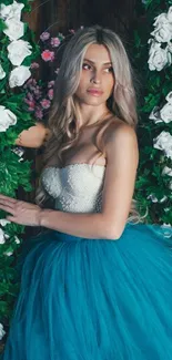 Elegant woman in teal dress surrounded by lush white flowers.